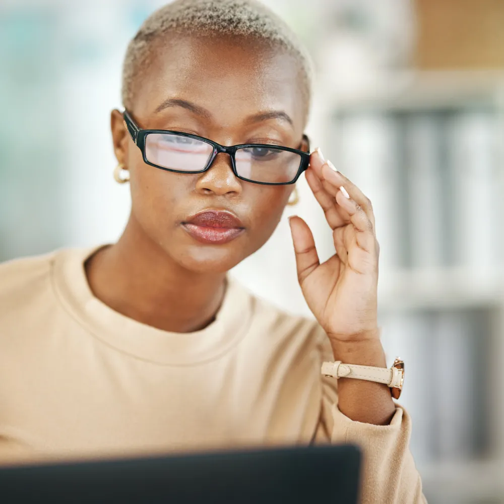 woman with glasses, reading email