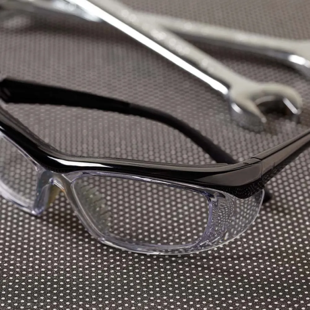 SAFETY GLASSES NEXT TO SOME WRENCHES